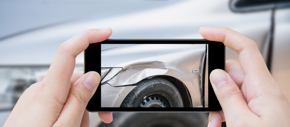 woman using mobile smartphone take car crash accident photo